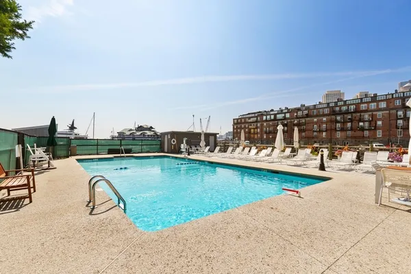 a view of a swimming pool and lounge chair