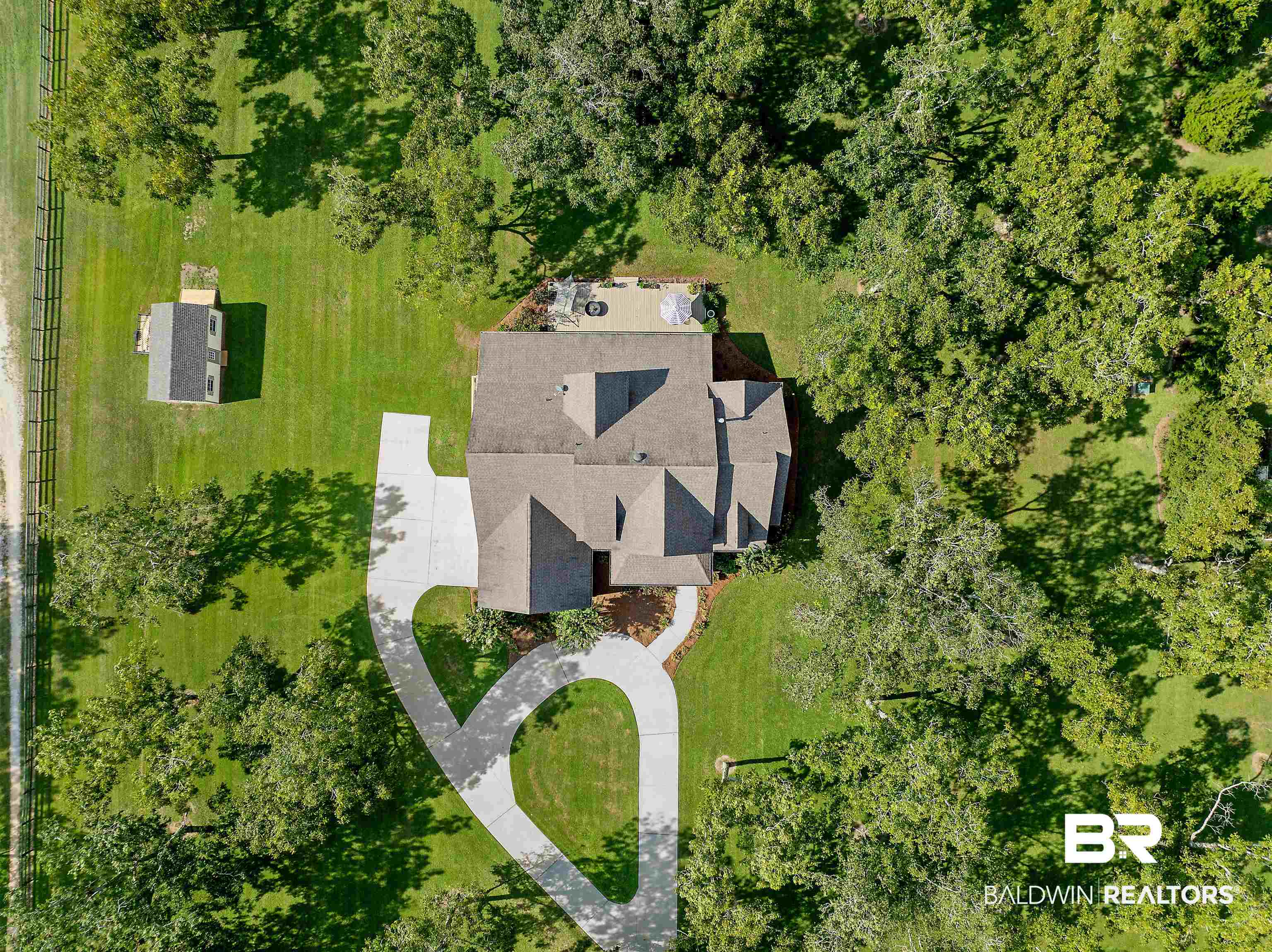 8753 Bishop Road Fairhope, AL 36532 - Photo 11 of 59 Expansive property featuring a main residence with a multi-gabled roofline, an accessory dwelling unit, a circular driveway, and mature landscaping