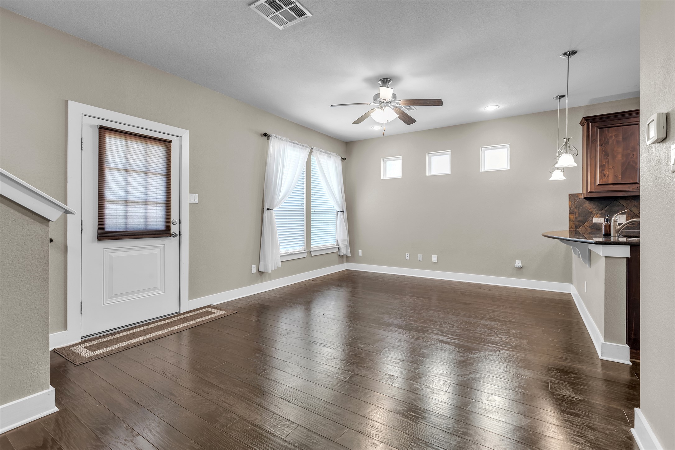 12212 Tawny Farms Road, Unit 142 Austin, TX 78748 - Photo 15 of 21 Hardwood floors stretch across this inviting living area, complemented by a contemporary ceiling fan and ample window light.
