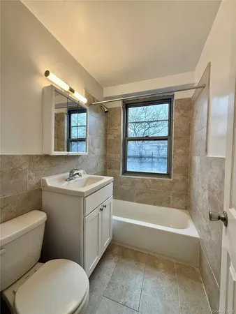 a bathroom with a sink a toilet and bathtub
