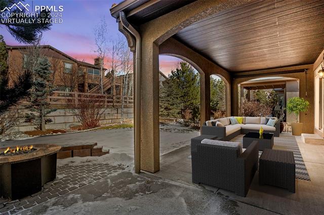2464 Cinnabar Road Colorado Springs, CO 80921 - Photo 35 of 43 Virtually Staged Patio terrace at dusk featuring an outdoor living space with a fire pit