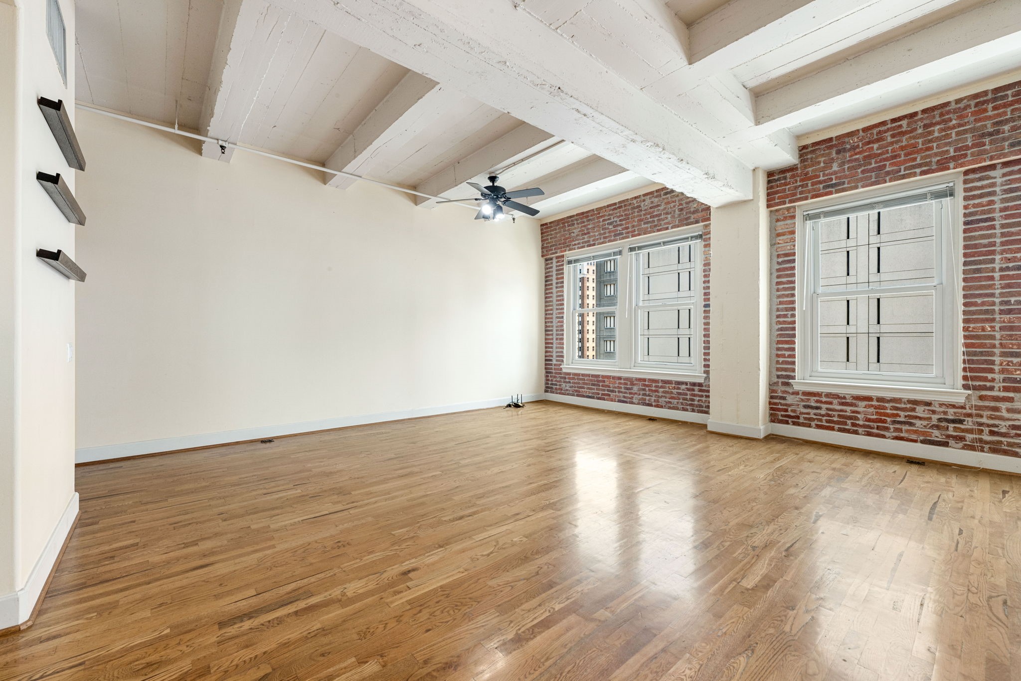 1120 Texas Street, Unit 7D Houston, TX 77002 - Photo 13 of 28 a view of livingroom with hardwood floor and window