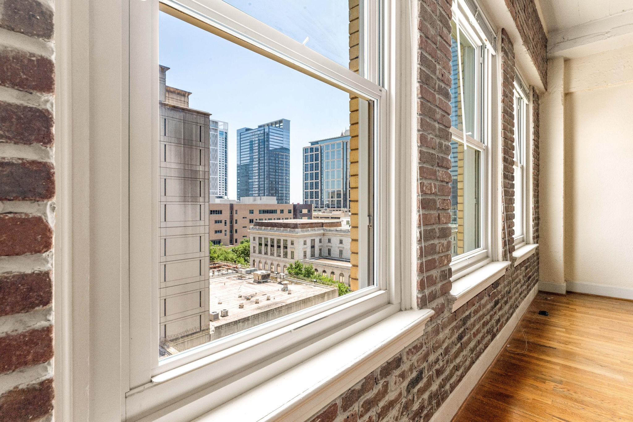 1120 Texas Street, Unit 7D Houston, TX 77002 - Photo 27 of 28 a view of a balcony with wooden floor