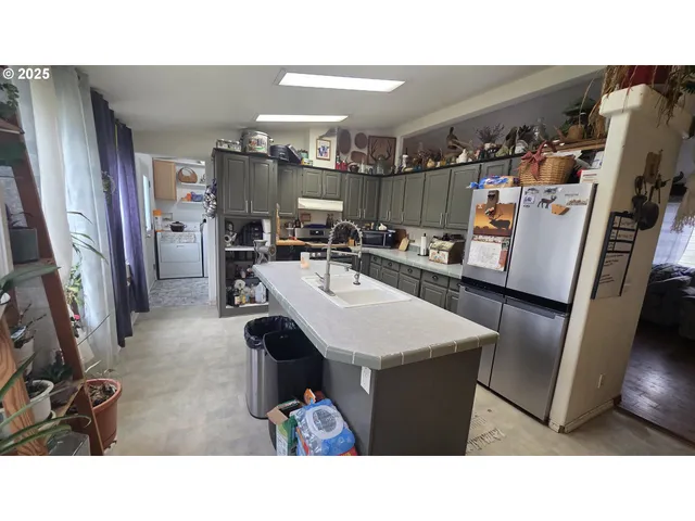 a kitchen with a sink a refrigerator and a stove