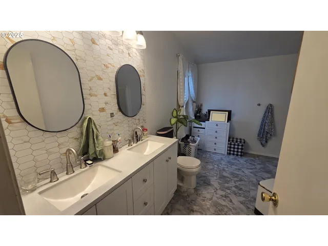 a bathroom with a sink mirror toilet and a mirror