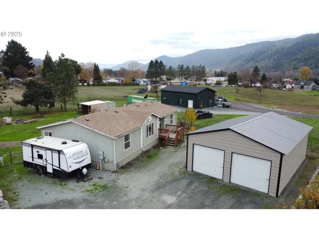 a aerial view of a house with outdoor space and seating