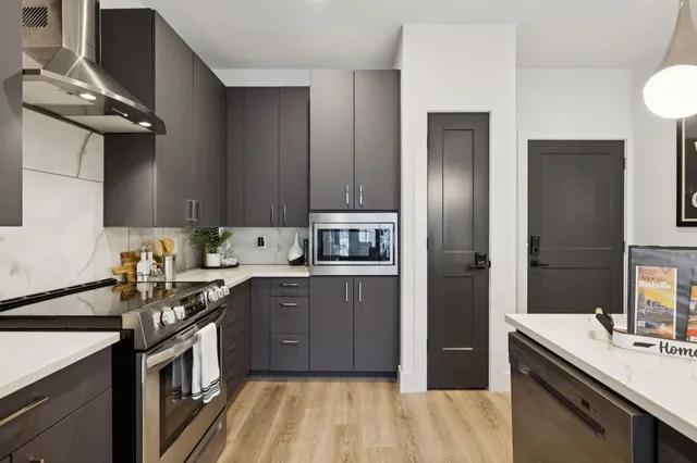 a vase of flowers sitting on a table with a potted plant