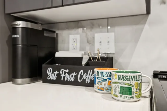 a kitchen with stainless steel appliances kitchen island granite countertop a sink and a refrigerator