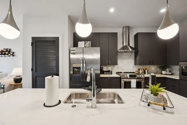 a kitchen with a table and refrigerator