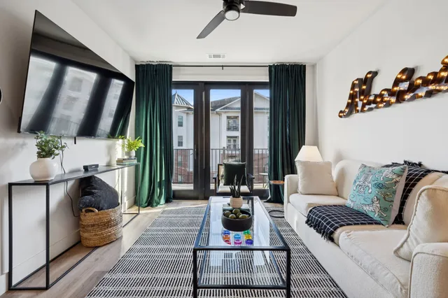 a living room with furniture and wooden floor