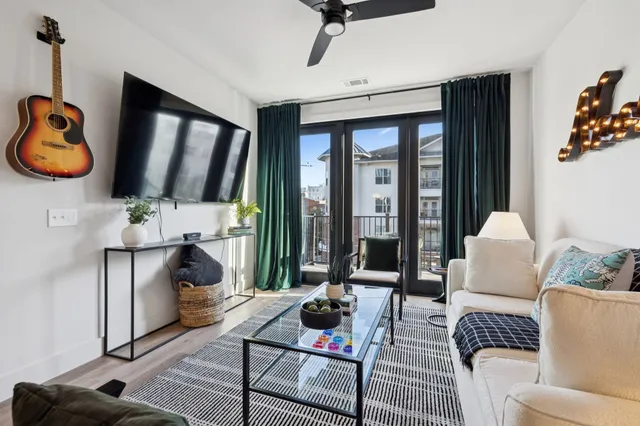 a living room with furniture kitchen view and a table