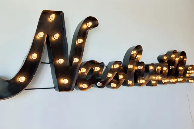 a living room with patio furniture and a flat screen tv