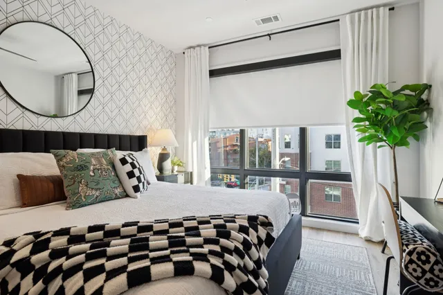 a bedroom with a bed and a flat screen tv