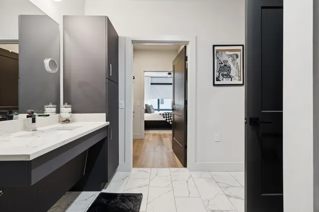 a bathroom with a double vanity sink and a mirror