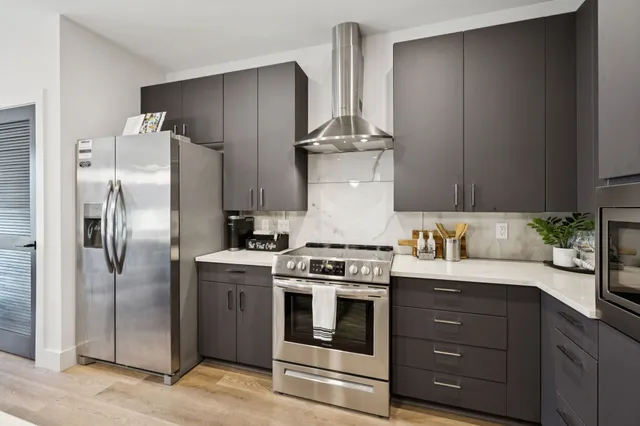 a kitchen with a refrigerator and a table