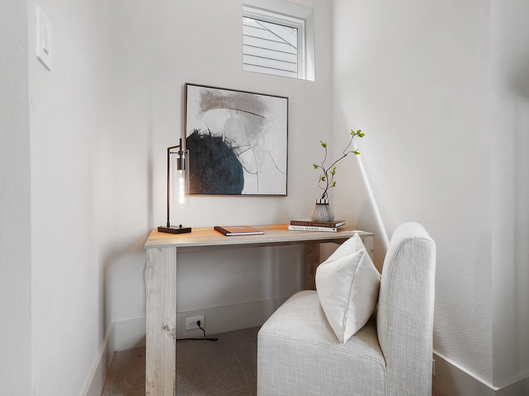 861 Rachel Street, Unit E Houston, TX 77091 - Photo 24 of 29 Discover a serene, light-filled nook in the primary bedroom, perfect for relaxing or reading, featuring a stylish desk and cozy chair for ultimate comfort.