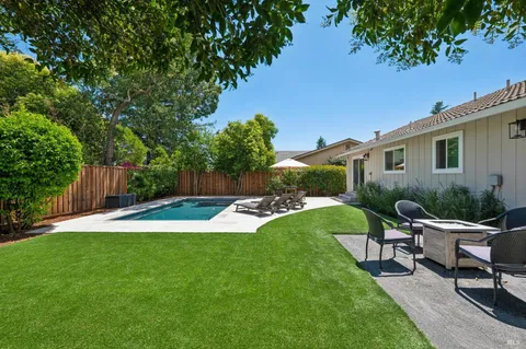 a view of backyard with wooden fence