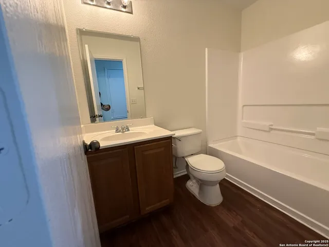 a bathroom with a toilet a sink and mirror