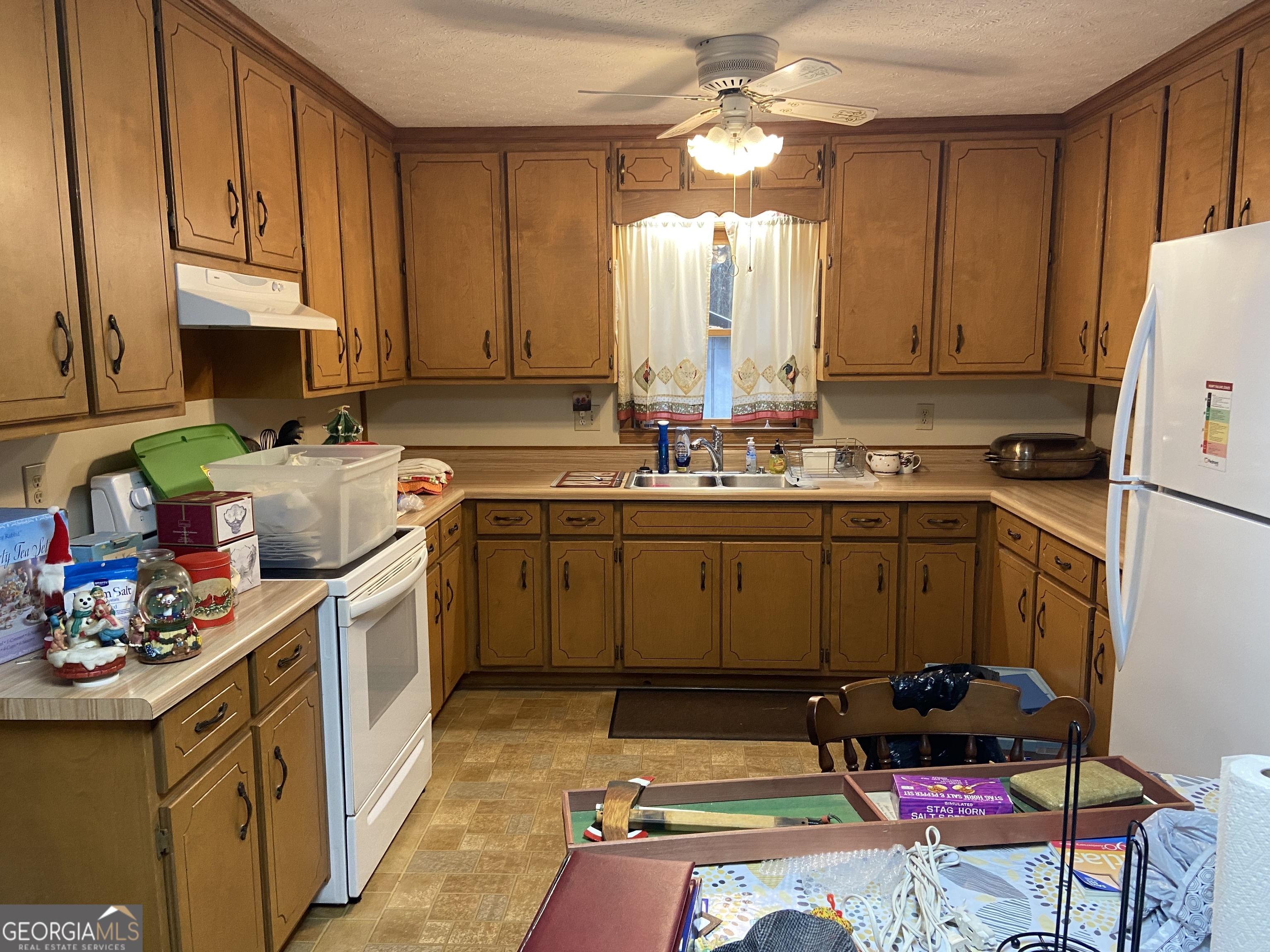1309 Tom Miller Road Bethlehem, GA 30620 - Photo 11 of 32 a kitchen with a sink stove and cabinets