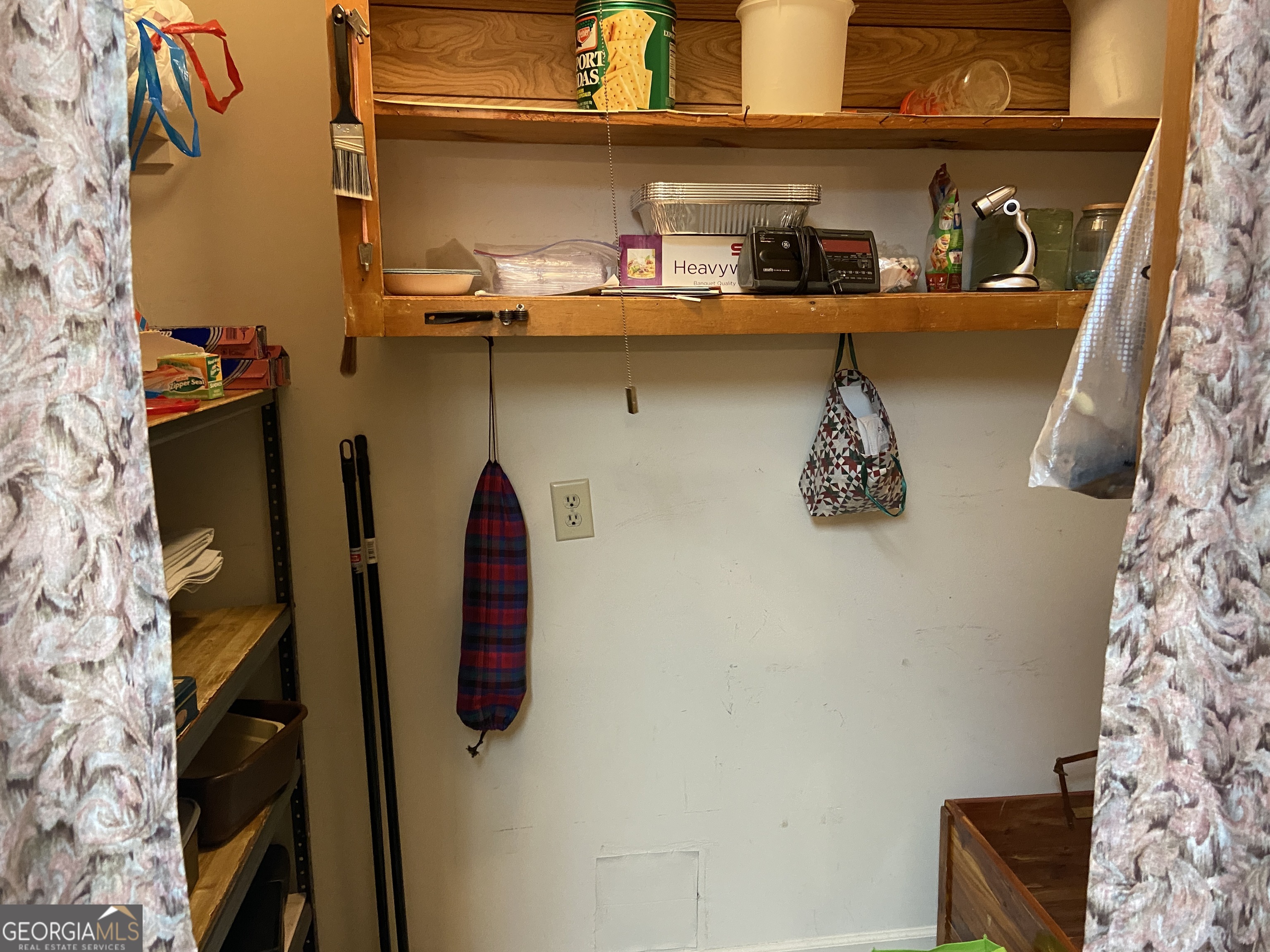 1309 Tom Miller Road Bethlehem, GA 30620 - Photo 14 of 32 a room with a walk in closet and a shower curtain