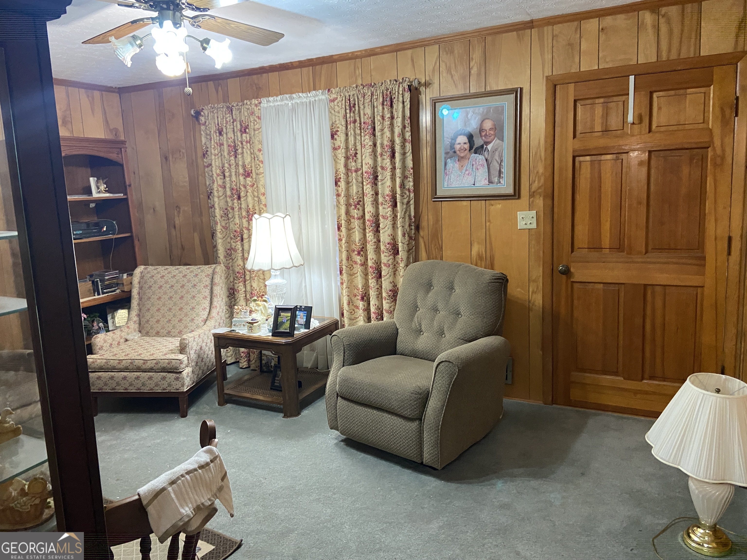 1309 Tom Miller Road Bethlehem, GA 30620 - Photo 27 of 32 a living room with furniture and a chandelier