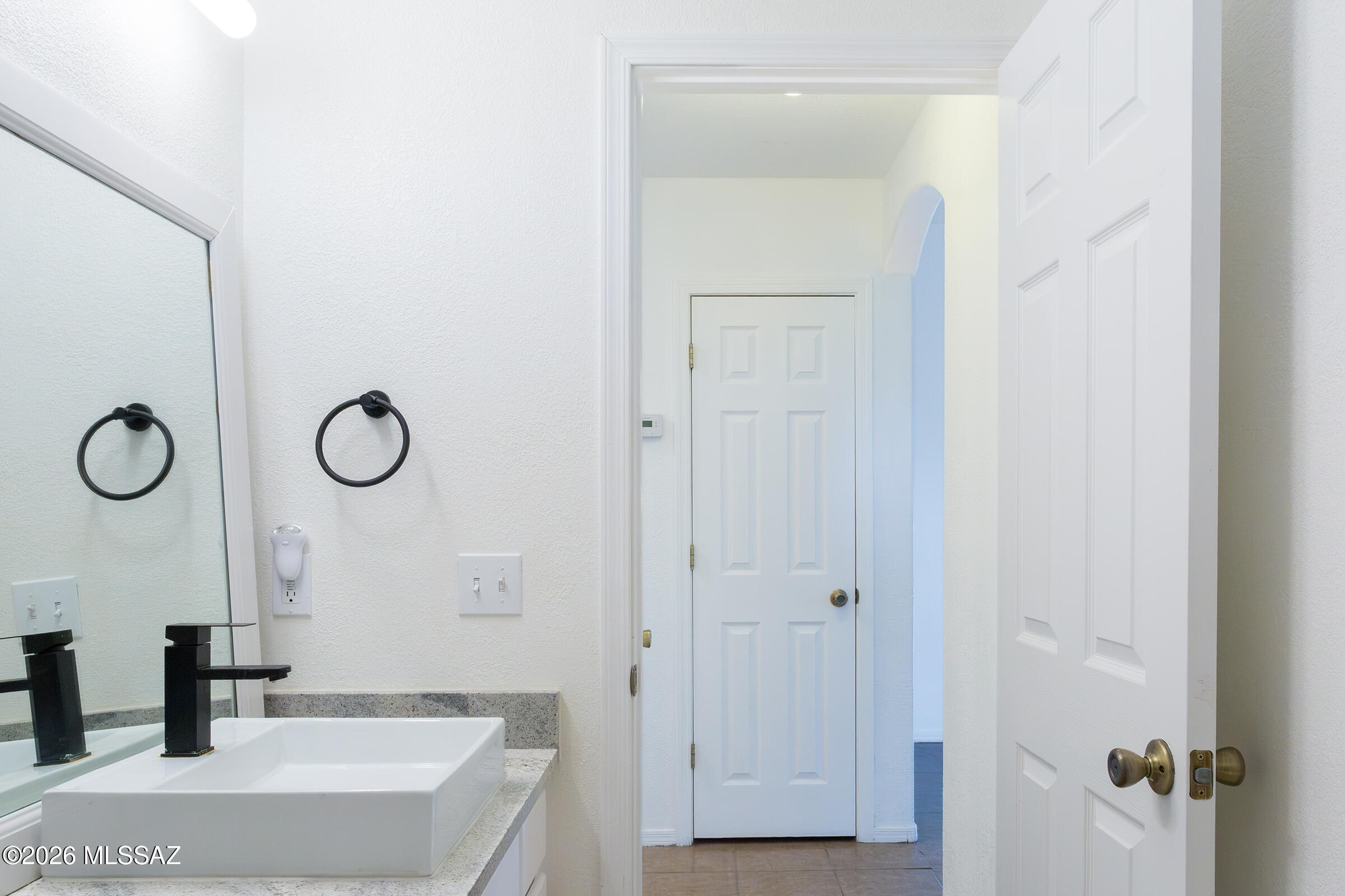1081 Paseo Freno Rio Rico, AZ 85648 - Photo 15 of 46 a bathroom with a granite countertop sink and a mirror