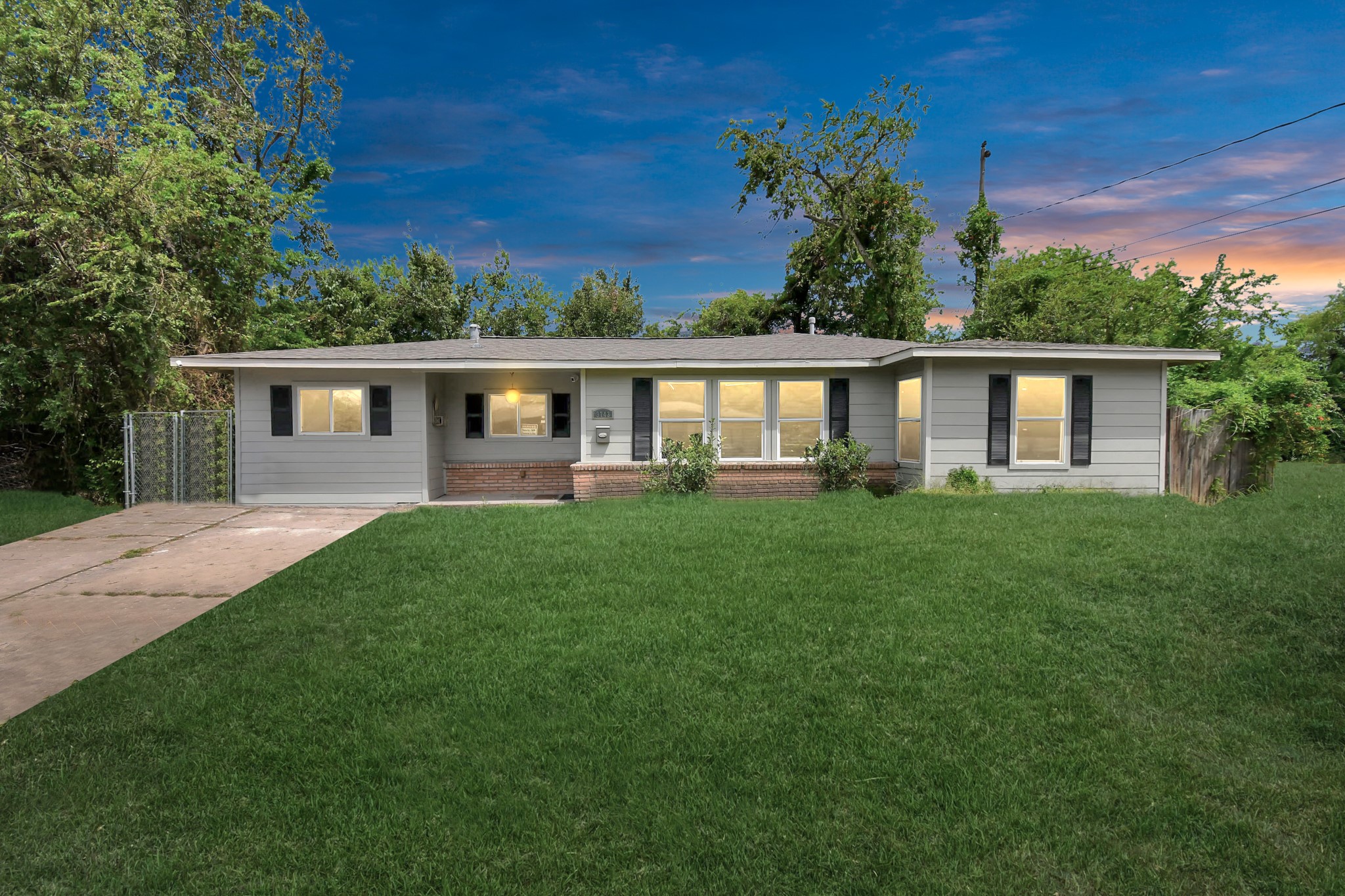 3743 Odin Court Houston, TX 77021 - Photo 1 of 36 Windows glow warmly against the charming exterior at twilight, perfectly fronted by a lush, deep green lawn that heightens the home's exceptional curb appeal.
