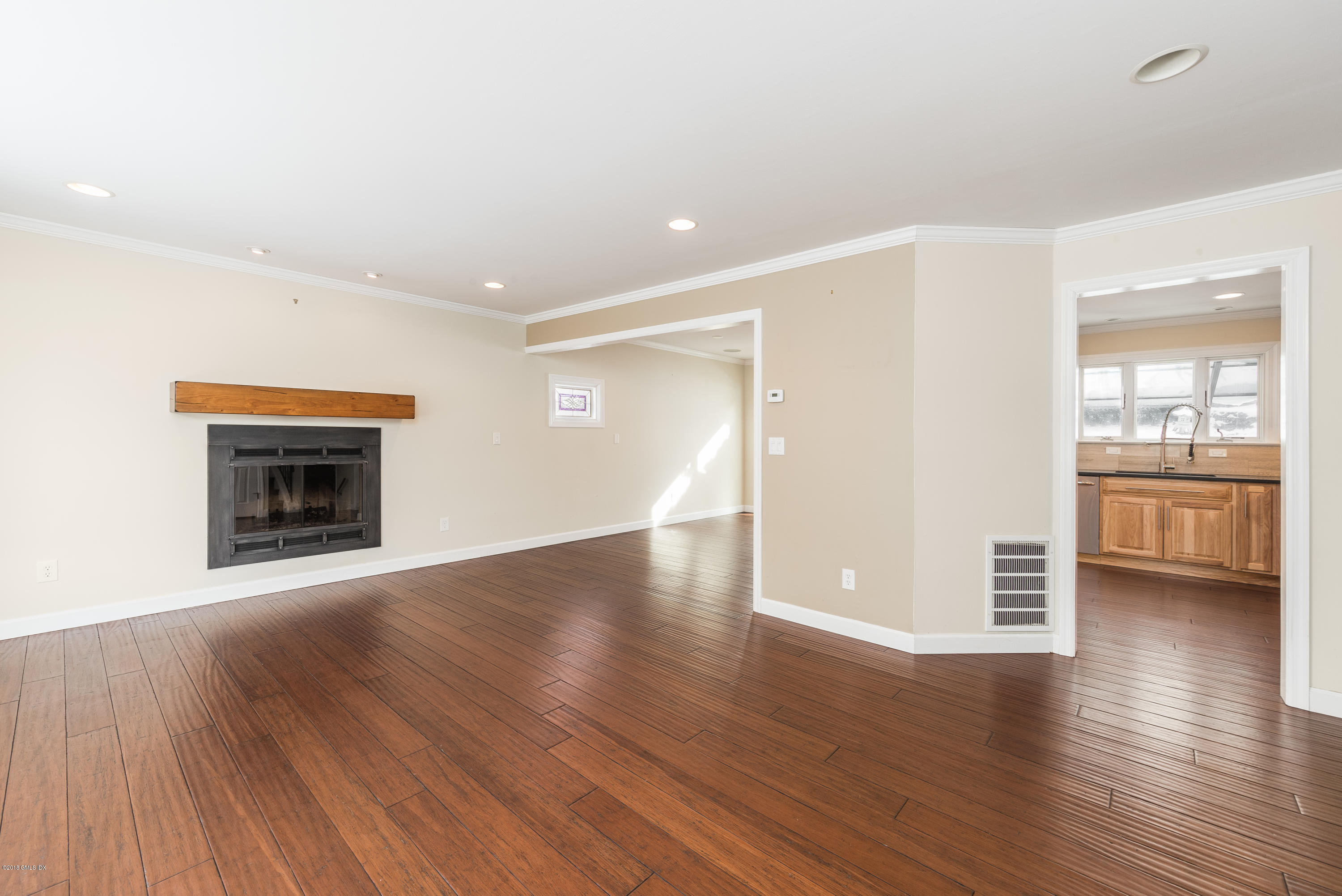80 Mary Lane Riverside, CT 06878 - Photo 3 of 15 an empty room with wooden floor fireplace and windows