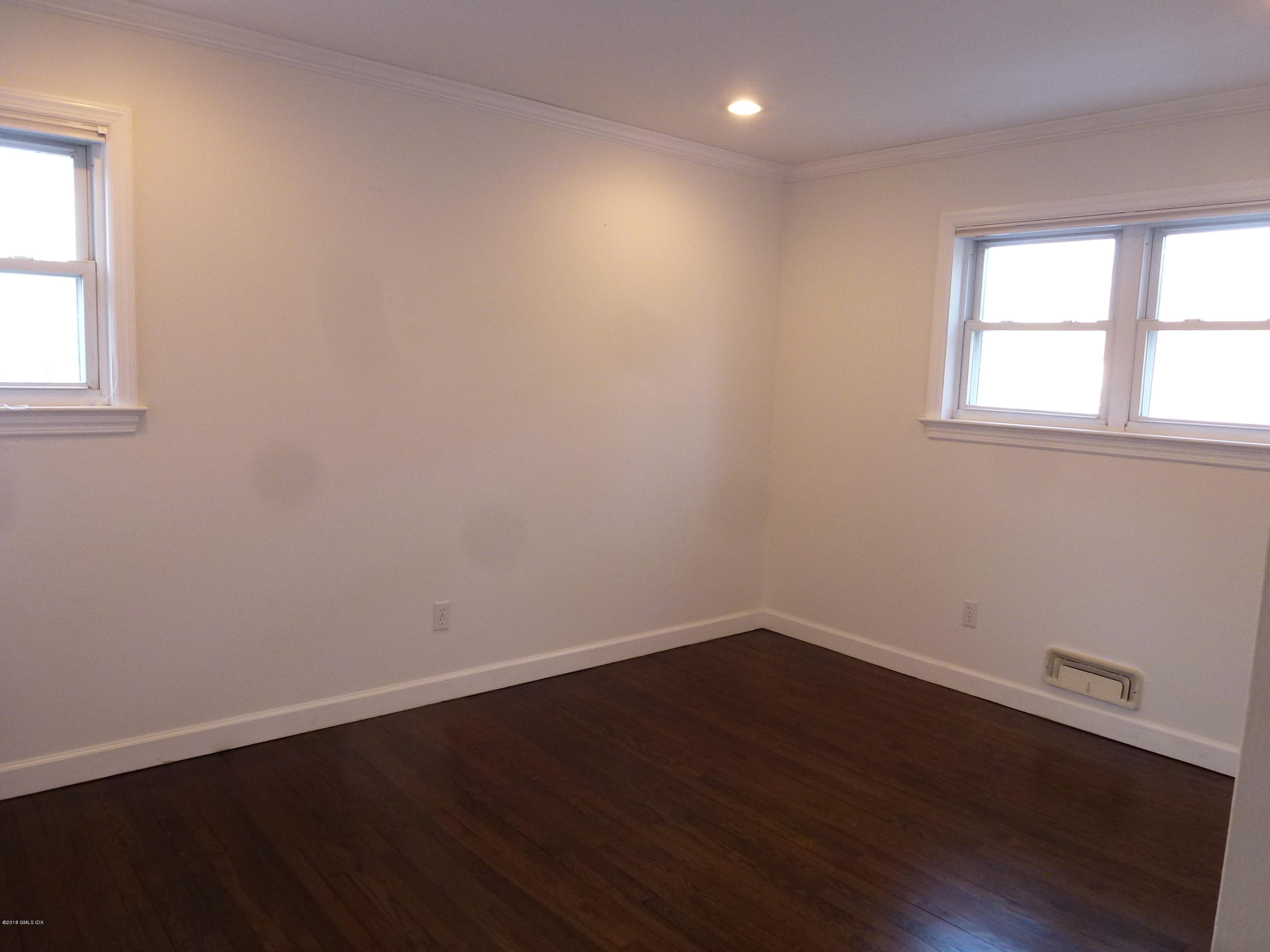 80 Mary Lane Riverside, CT 06878 - Photo 9 of 15 an empty room with wooden floor and windows