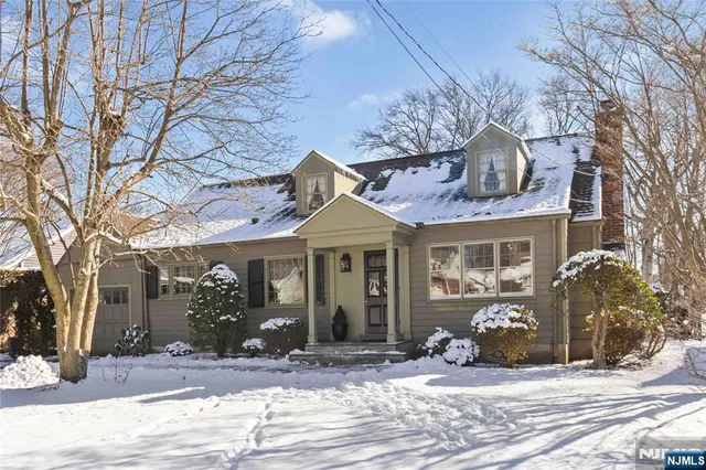 a view of a house with a yard and garage