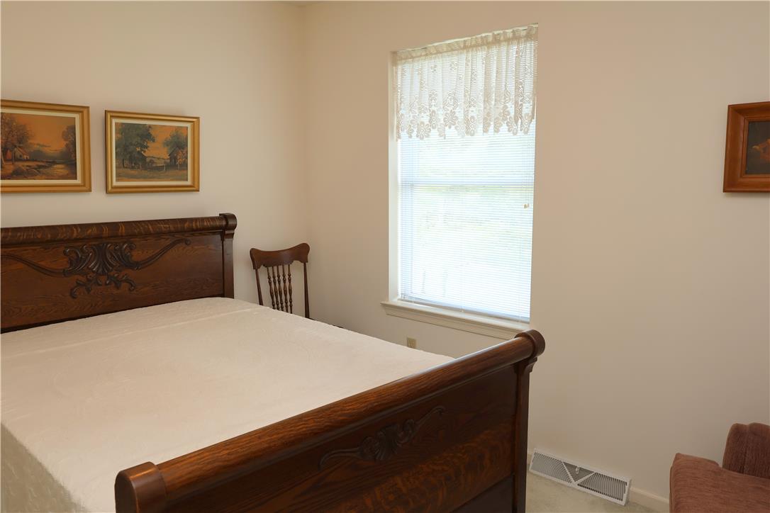 1282 Old Gate Road Northampton, PA 18067 - Photo 12 of 18 A quiet retreat, this bedroom offers a carved wood bed frame and natural light from a well-sized window.