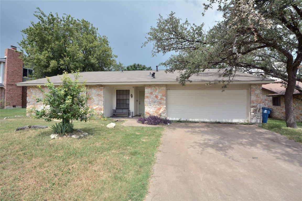 12327 Deerbrook Trail Austin, TX 78750 - Photo 1 of 20 front view of a house with a yard and an trees