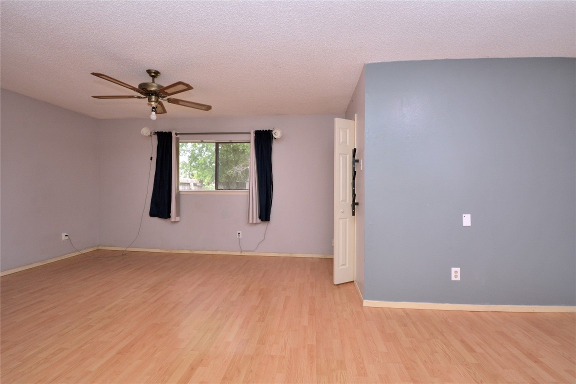 12327 Deerbrook Trail Austin, TX 78750 - Photo 11 of 20 wooden floor in an empty room with a window