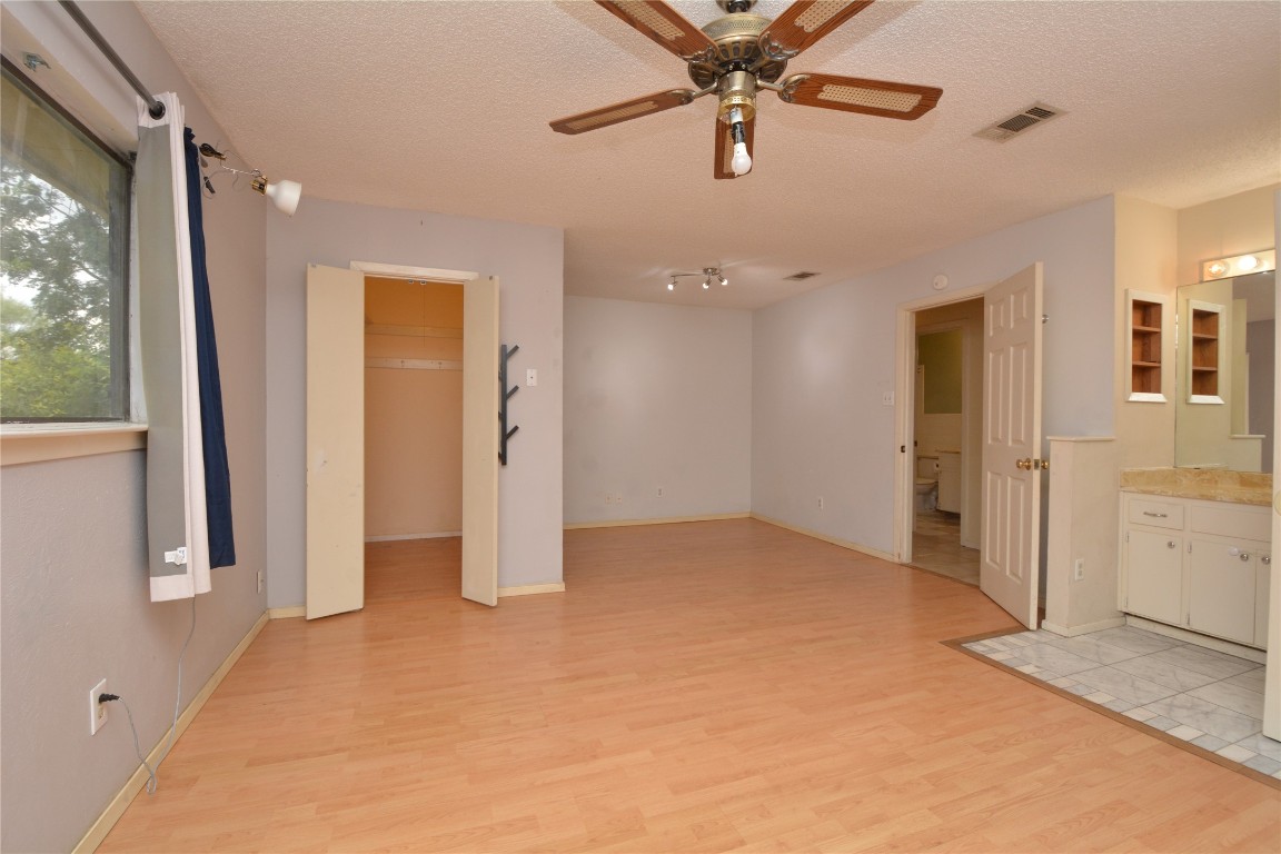 12327 Deerbrook Trail Austin, TX 78750 - Photo 12 of 20 an empty room with closet and a chandelier fan