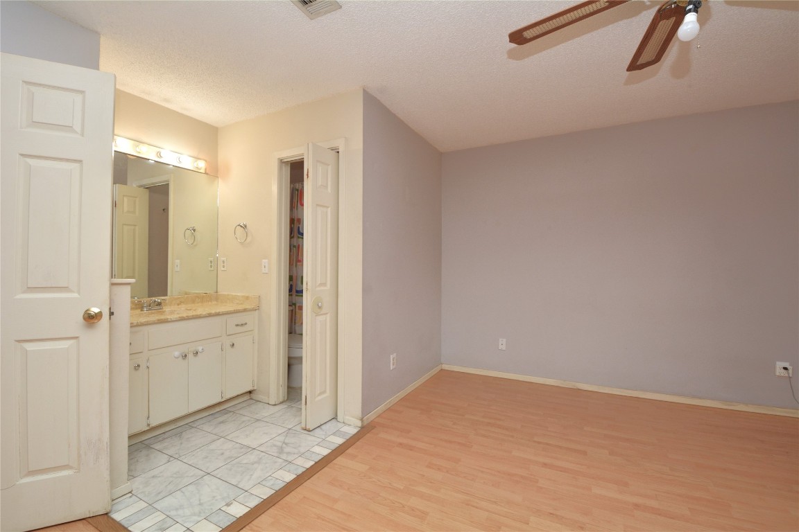 12327 Deerbrook Trail Austin, TX 78750 - Photo 13 of 20 a bathroom with a granite countertop sink and shower