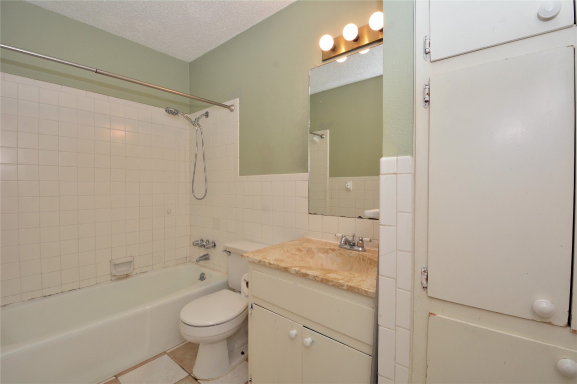 12327 Deerbrook Trail Austin, TX 78750 - Photo 16 of 20 a bathroom with a granite countertop sink toilet and shower