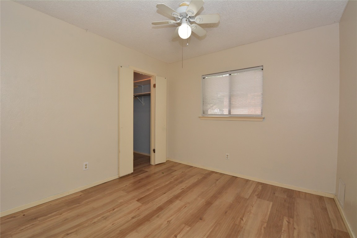 12327 Deerbrook Trail Austin, TX 78750 - Photo 18 of 20 wooden floor in an empty room with a window