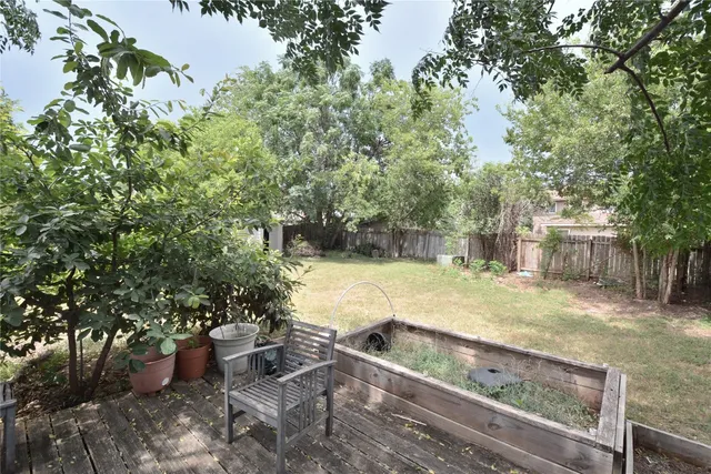 a view of a backyard with large trees