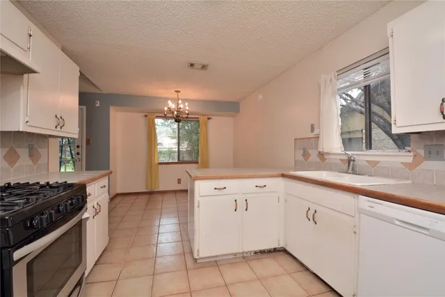 a kitchen that has a sink and a stove