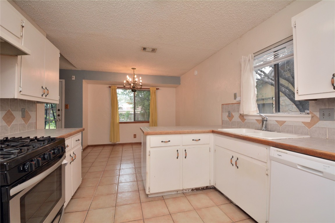 12327 Deerbrook Trail Austin, TX 78750 - Photo 10 of 20 a kitchen that has a sink and a stove