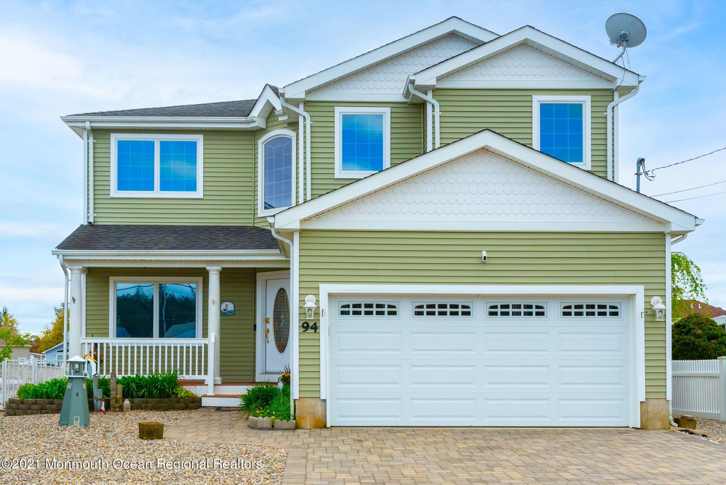 94 Cedar Run Road Bayville, NJ 08721 - Photo 1 of 43 a front view of a house with a garden
