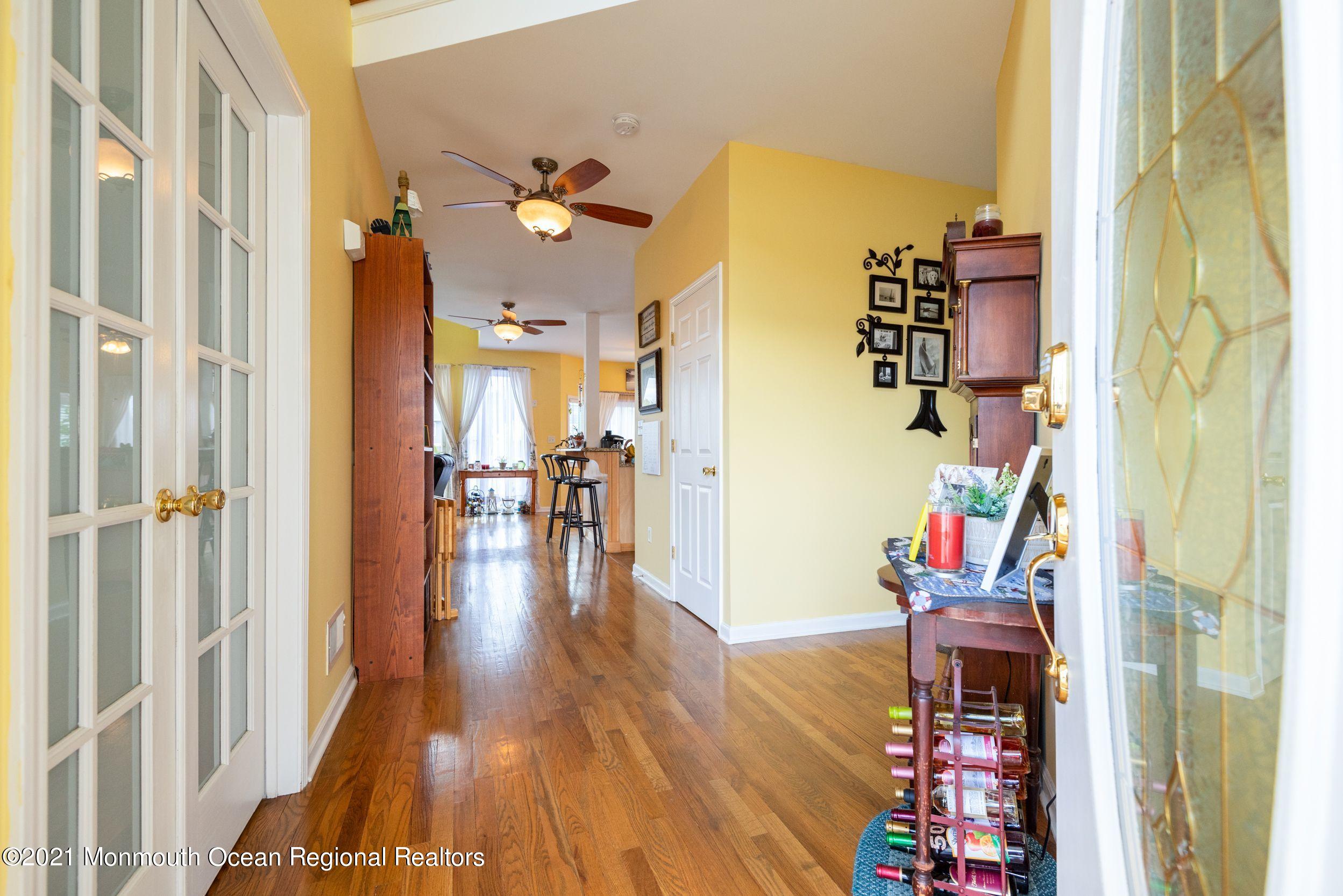 94 Cedar Run Road Bayville, NJ 08721 - Photo 11 of 43 a view of a hallway with wooden floor and toys