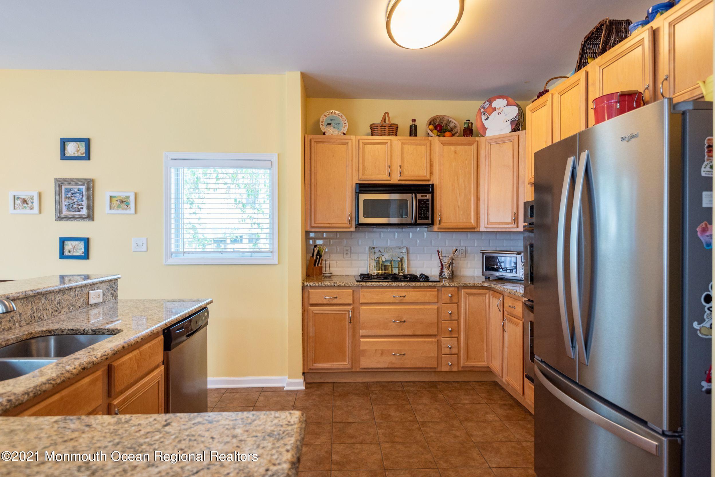 94 Cedar Run Road Bayville, NJ 08721 - Photo 13 of 43 a kitchen with stainless steel appliances granite countertop a refrigerator stove top oven and sink