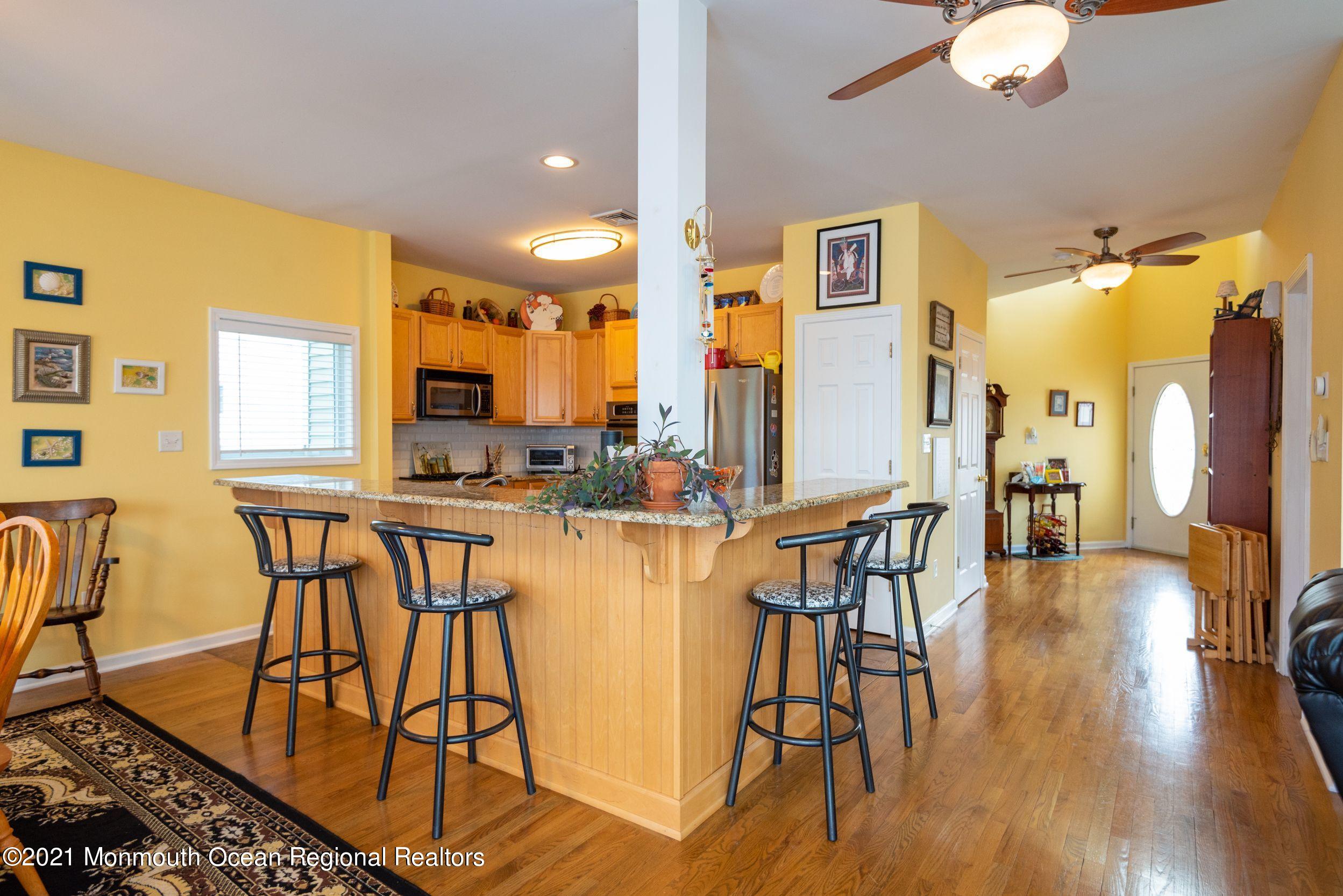 94 Cedar Run Road Bayville, NJ 08721 - Photo 15 of 43 a view of a dining room with furniture and wooden floor