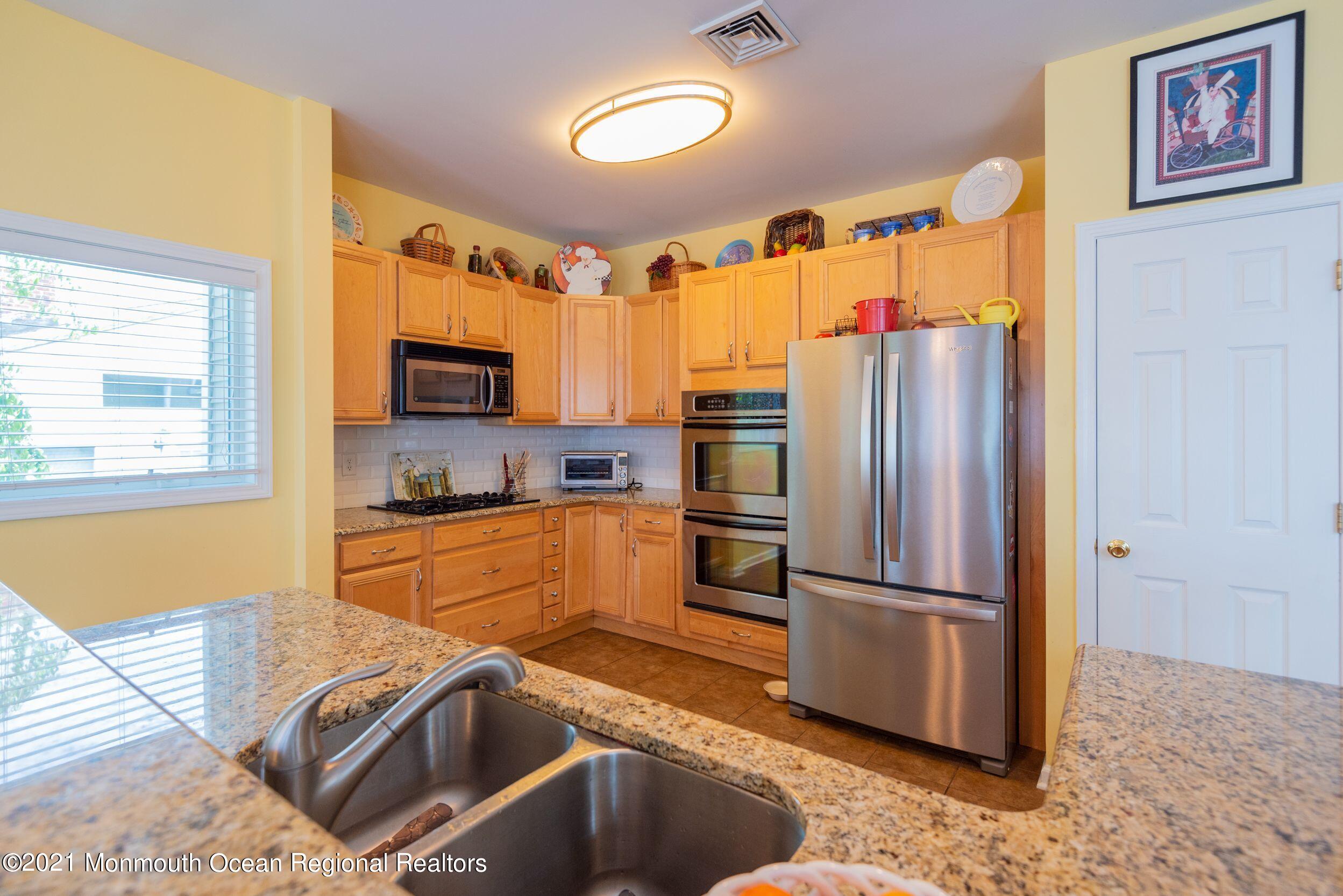 94 Cedar Run Road Bayville, NJ 08721 - Photo 16 of 43 a kitchen with granite countertop stainless steel appliances a refrigerator stove top oven and sink