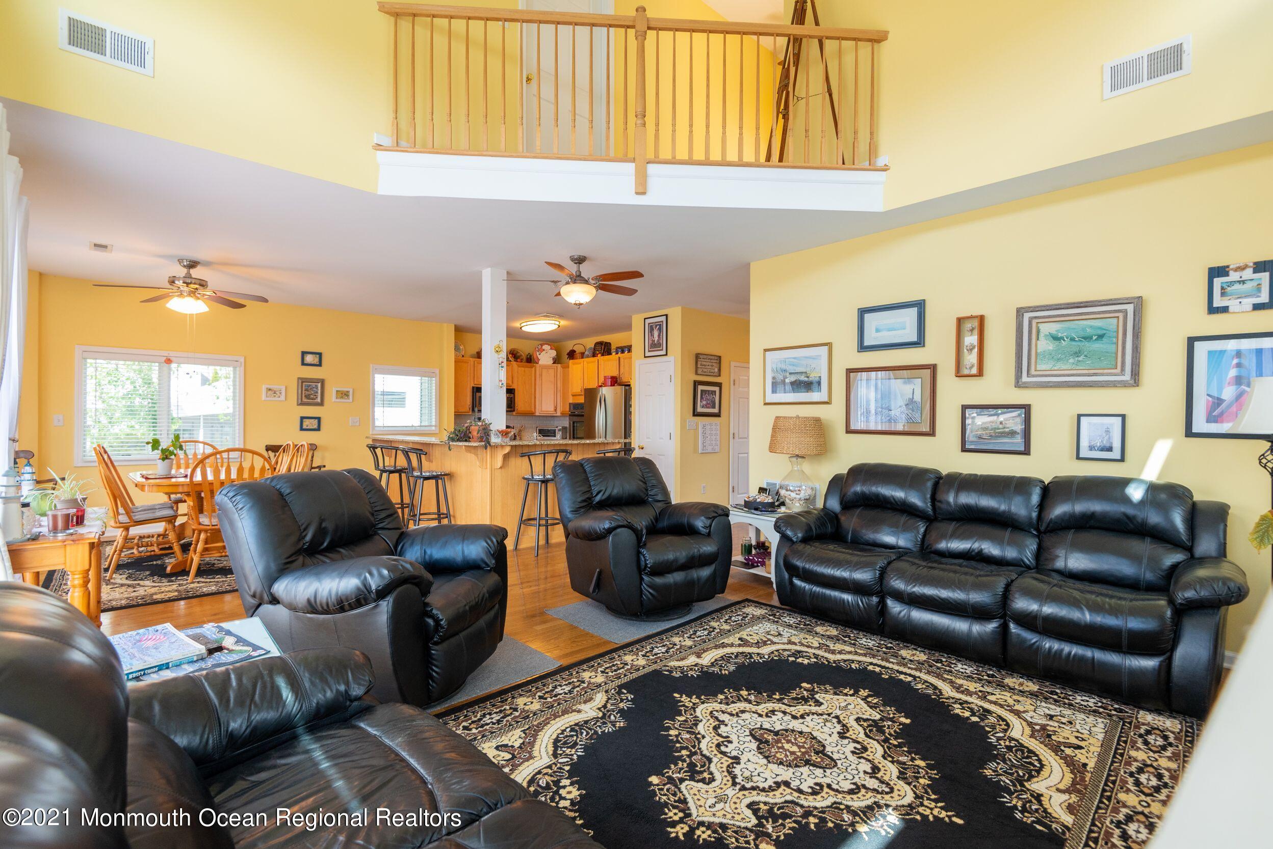 94 Cedar Run Road Bayville, NJ 08721 - Photo 20 of 43 a living room with furniture ceiling fan and a rug