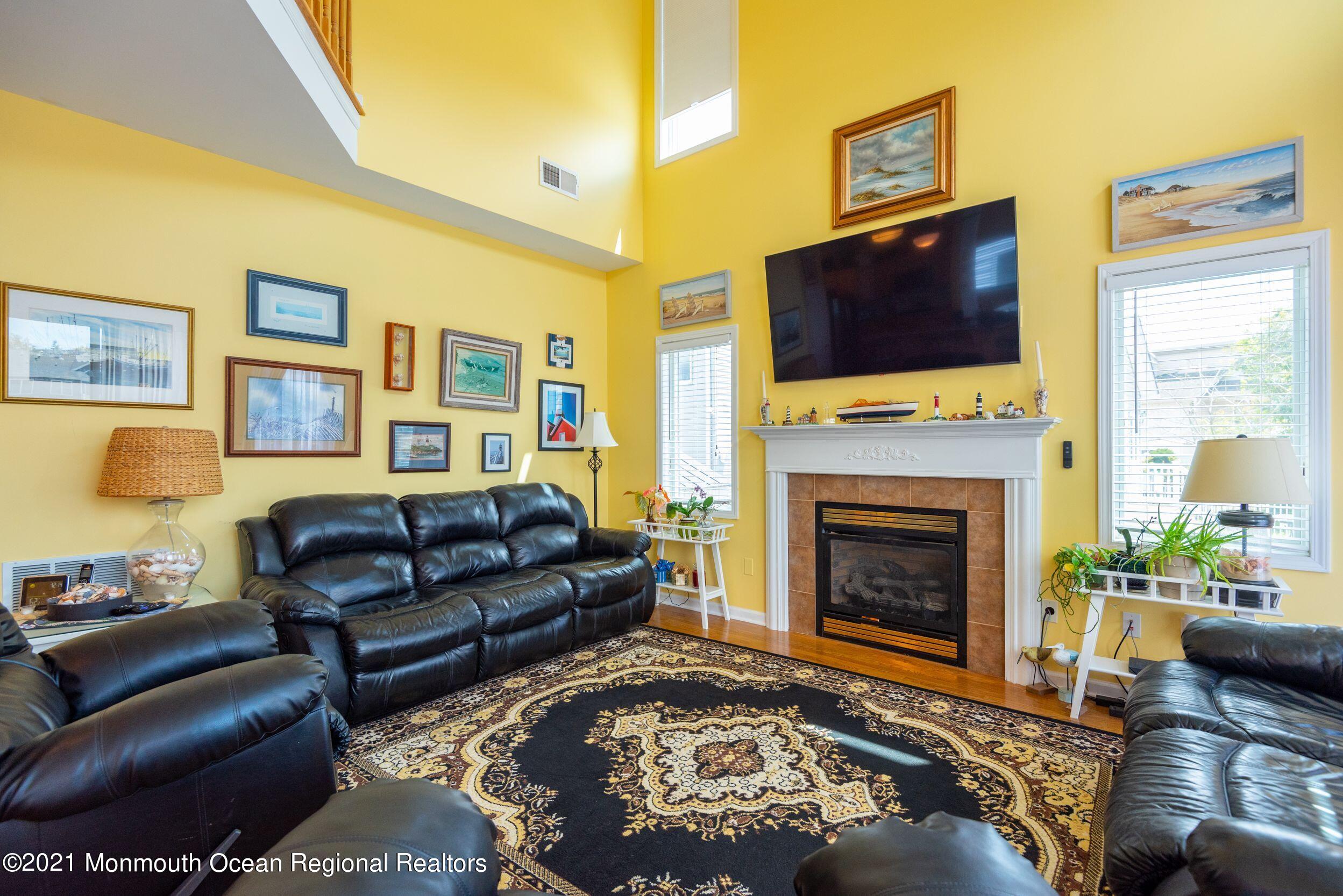 94 Cedar Run Road Bayville, NJ 08721 - Photo 21 of 43 a living room with furniture fireplace and flat screen tv