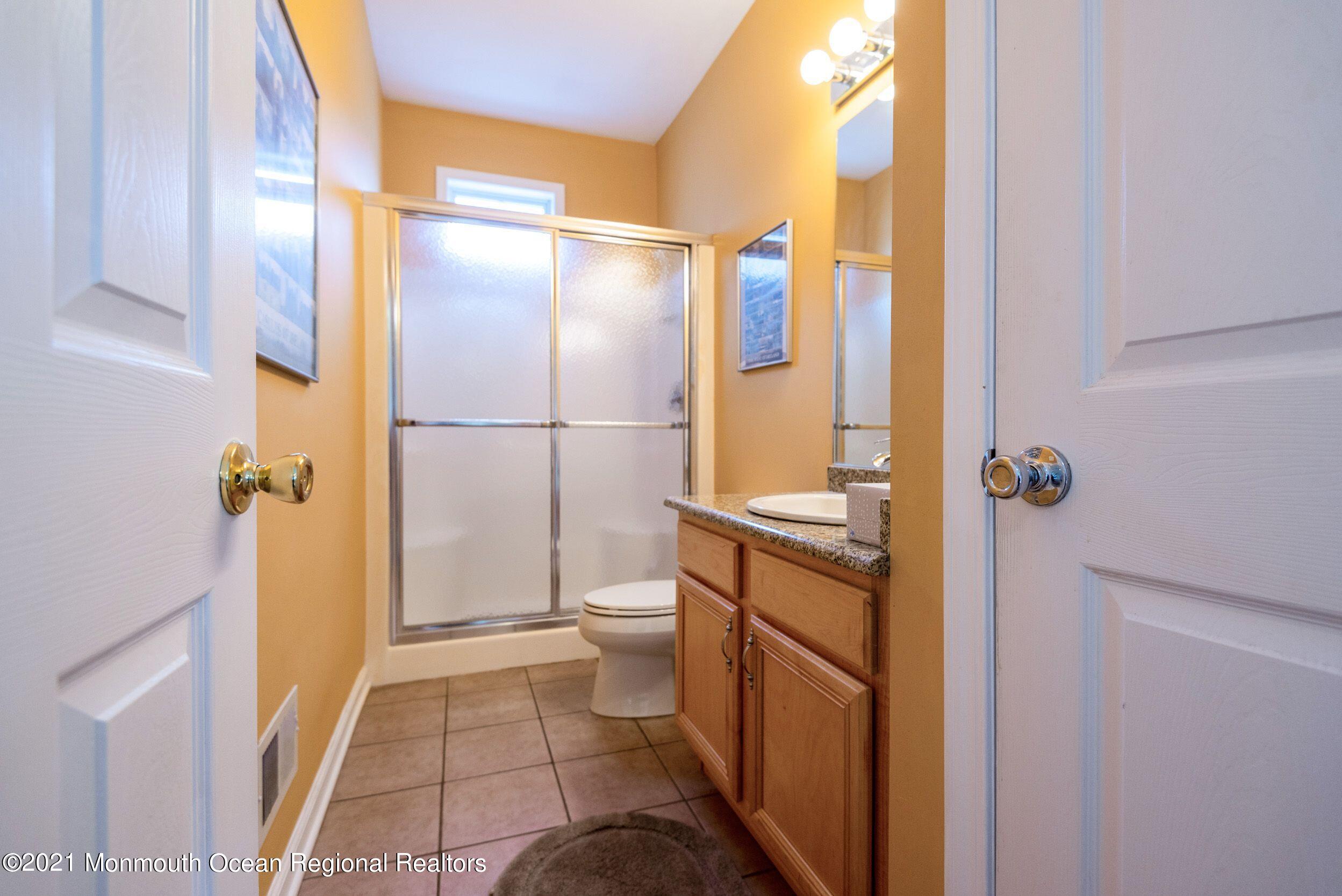 94 Cedar Run Road Bayville, NJ 08721 - Photo 23 of 43 a bathroom with a sink a toilet and shower