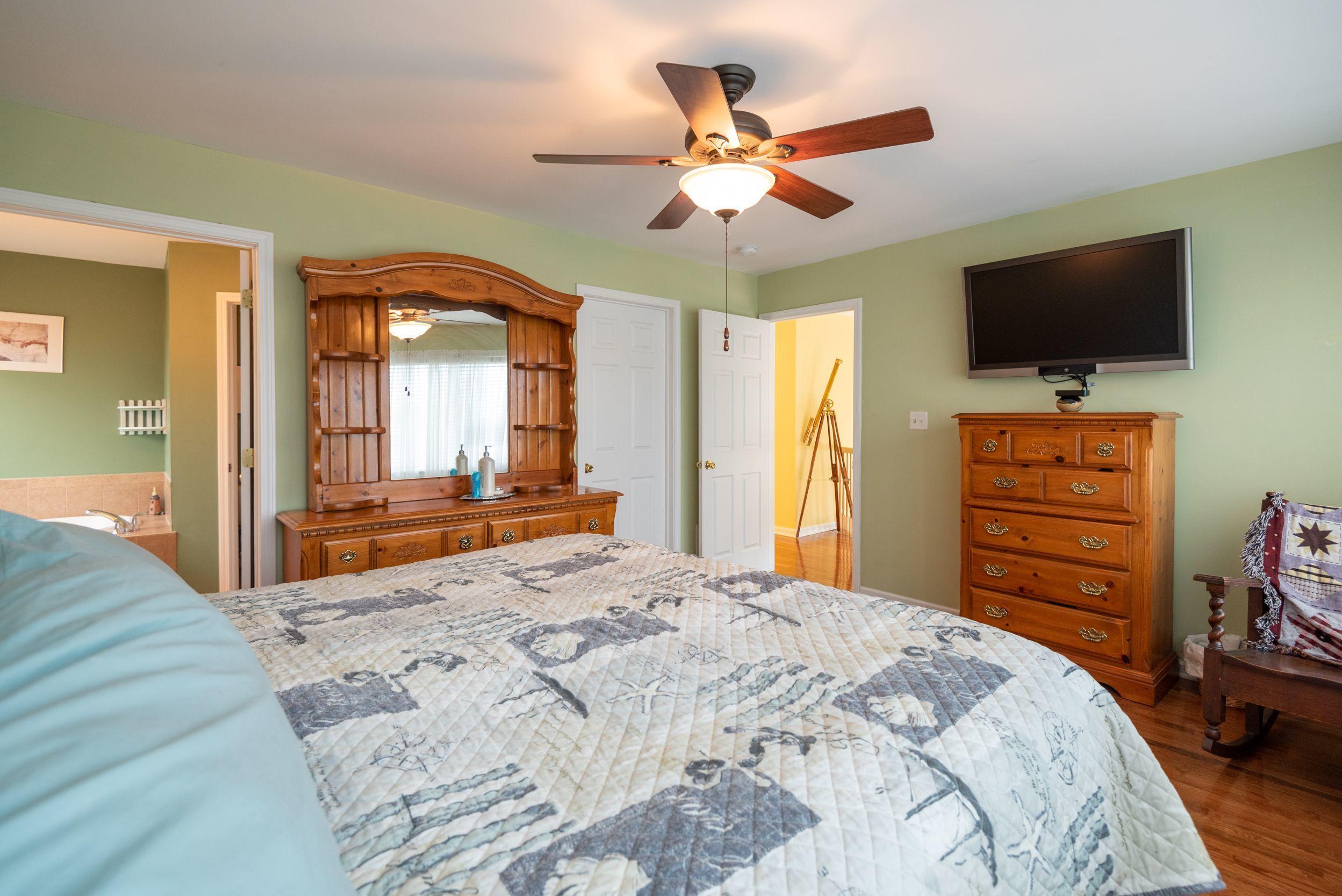 94 Cedar Run Road Bayville, NJ 08721 - Photo 25 of 43 a bedroom with a bed a flat screen tv and dresser