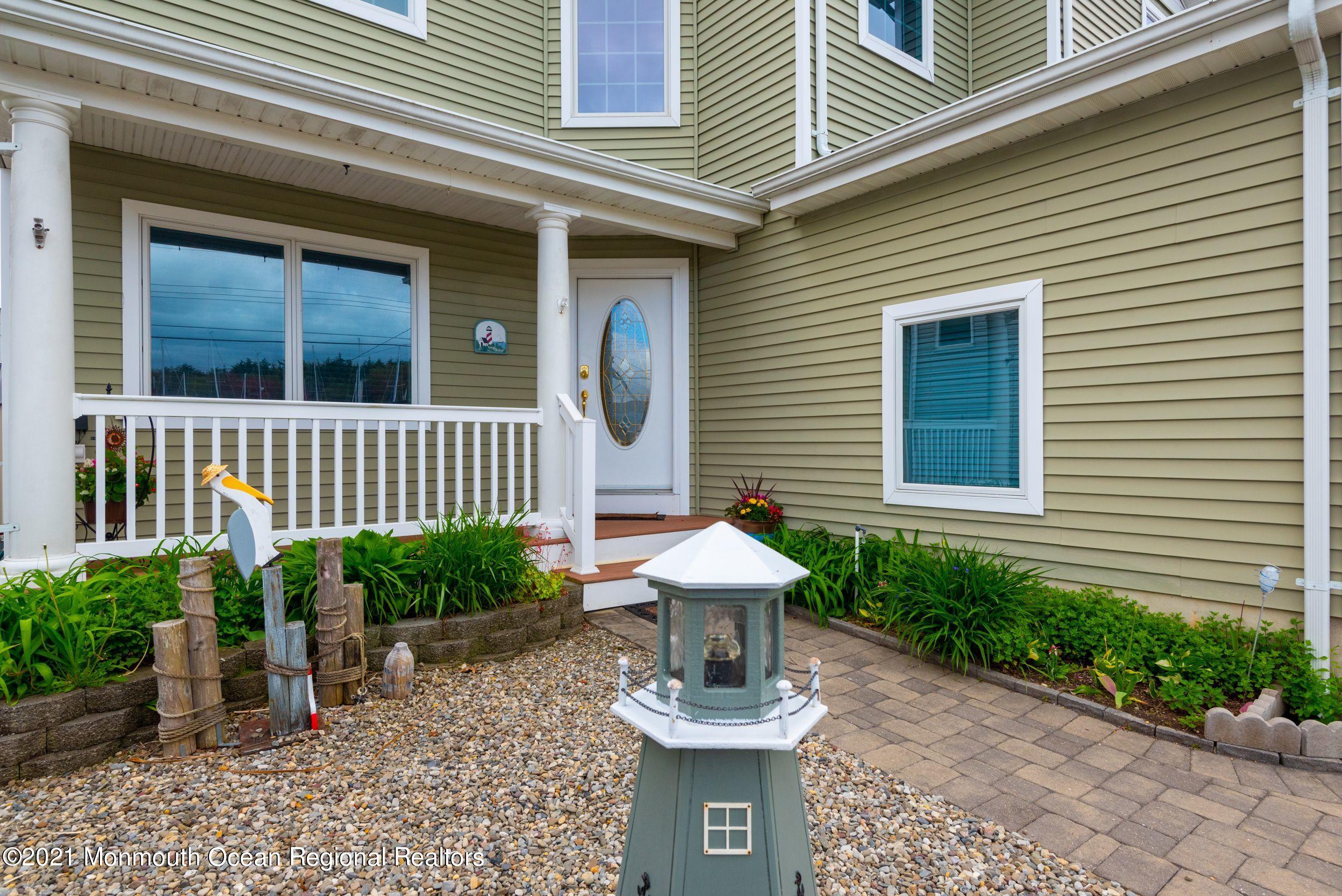 94 Cedar Run Road Bayville, NJ 08721 - Photo 9 of 43 a view of a house with a small window and potted plants